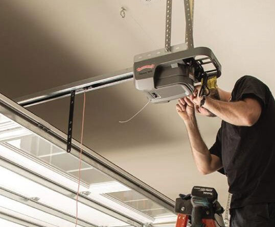 a technician repairing a garage door opener, representing expert services available in Myakka City, Florida. Keywords: garage door opener repair.